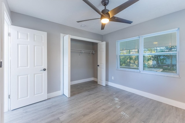 unfurnished bedroom with light wood-type flooring, a closet, and ceiling fan