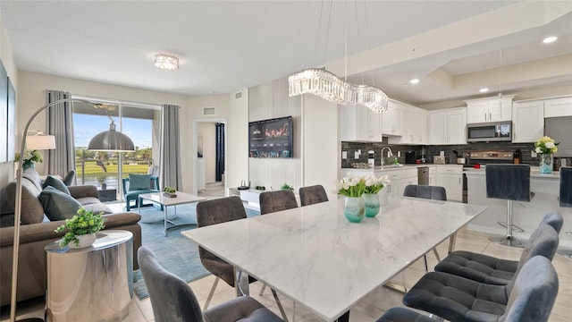 dining space with light tile patterned floors and sink