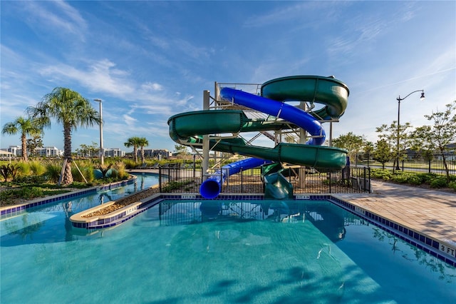 view of pool featuring a patio area and a water slide