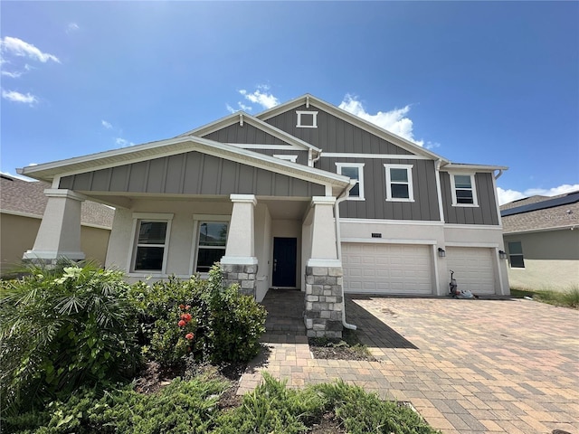 view of front of house featuring a porch and a garage