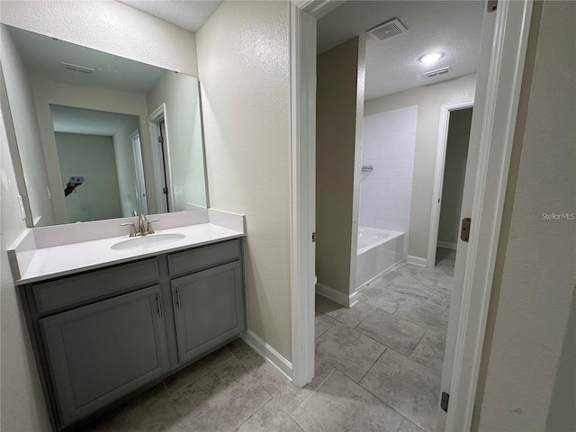 bathroom featuring vanity and a textured ceiling