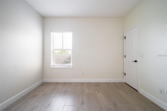 unfurnished room with light wood-type flooring