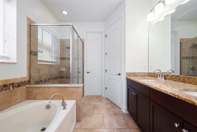 bathroom featuring tile patterned floors, vanity, and plus walk in shower