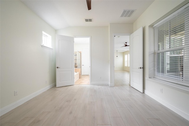 unfurnished bedroom featuring ceiling fan, connected bathroom, and light hardwood / wood-style flooring