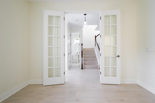 hallway featuring light hardwood / wood-style flooring and french doors