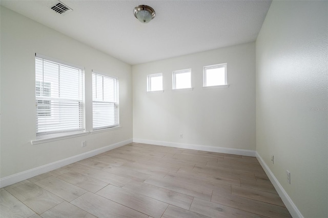 spare room featuring light hardwood / wood-style flooring