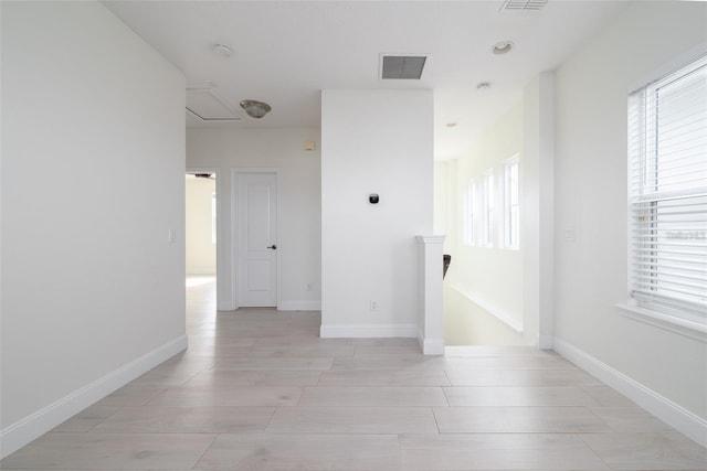empty room featuring visible vents and baseboards