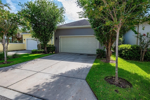 view of front of property with concrete driveway and a front lawn