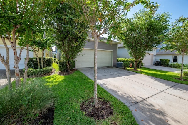 obstructed view of property featuring an attached garage, a front yard, and concrete driveway