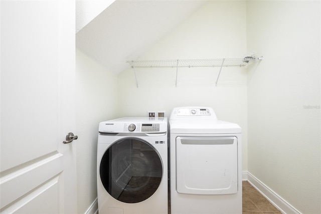 laundry room with independent washer and dryer, laundry area, baseboards, and tile patterned flooring