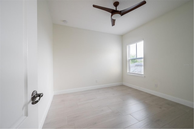 unfurnished room with ceiling fan and baseboards