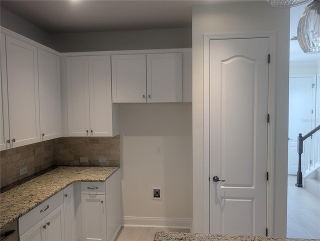 kitchen with white cabinetry and tasteful backsplash