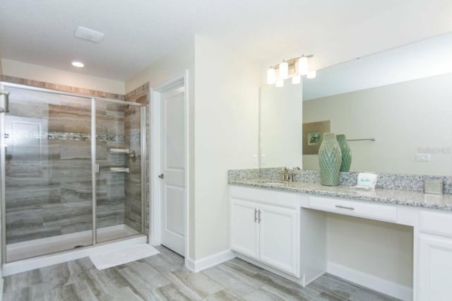 bathroom featuring hardwood / wood-style floors, vanity, and walk in shower