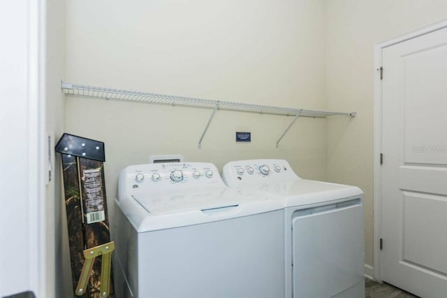 clothes washing area with washer and clothes dryer