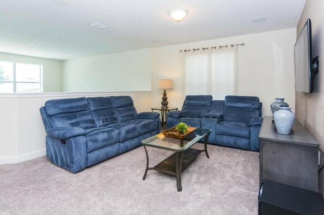 carpeted living room with a healthy amount of sunlight