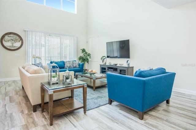 living room featuring a towering ceiling