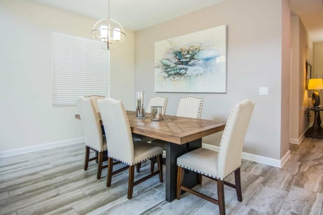 dining area with light wood-type flooring and a notable chandelier