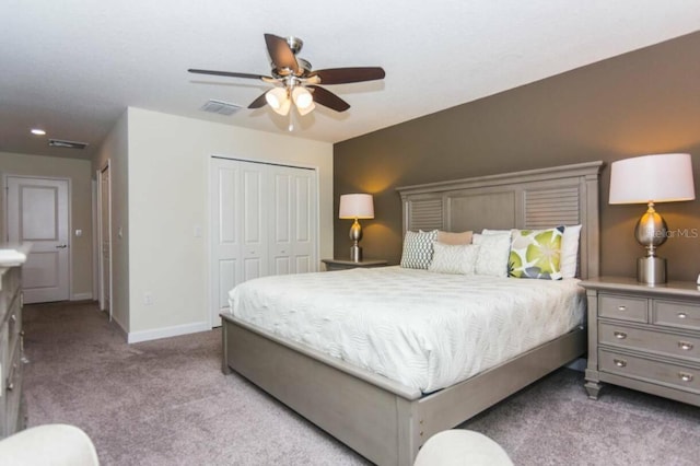 carpeted bedroom with ceiling fan and a closet