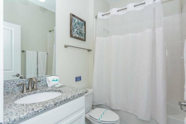 full bathroom featuring vanity, toilet, and shower / tub combo with curtain