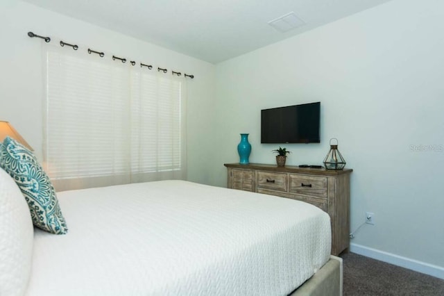 bedroom with dark colored carpet