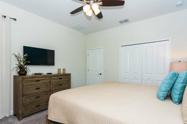 bedroom featuring ceiling fan, a closet, and light carpet