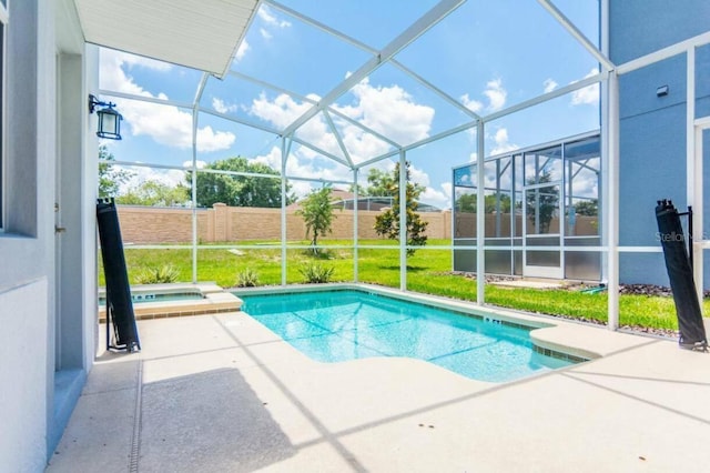 view of pool featuring a lanai, an in ground hot tub, and a patio