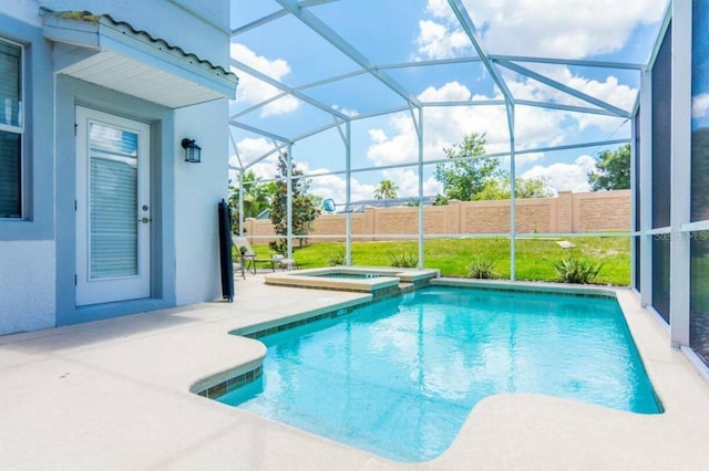 view of pool featuring a lanai, a patio area, and an in ground hot tub