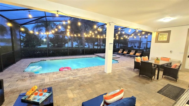 view of pool featuring a patio area, a lanai, and an in ground hot tub