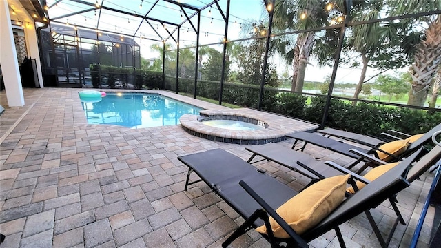 view of swimming pool featuring a lanai, an in ground hot tub, and a patio