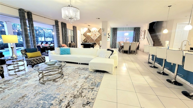 living room featuring plenty of natural light, light tile patterned floors, and a chandelier