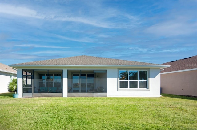 rear view of property with a lawn