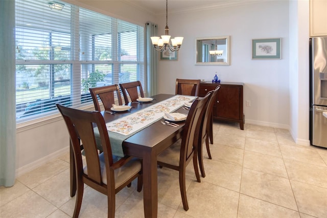 tiled dining area featuring a notable chandelier and ornamental molding