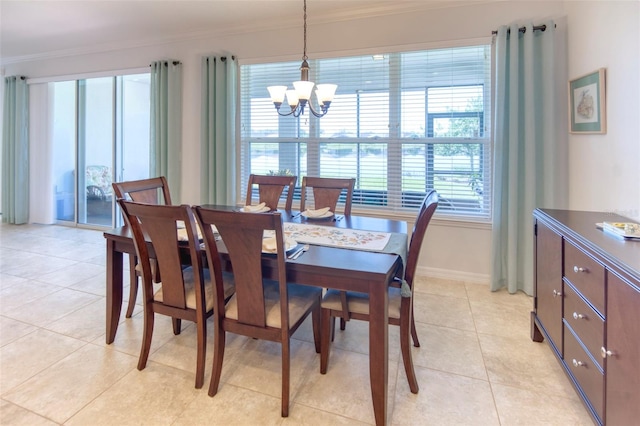 tiled dining area featuring ornamental molding and a chandelier