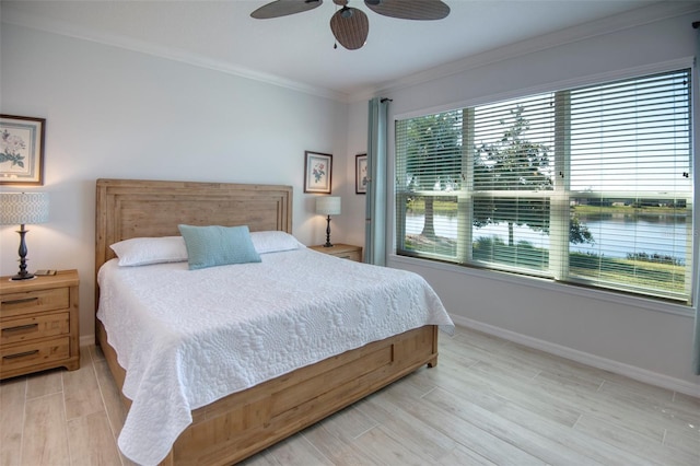 bedroom featuring ceiling fan, crown molding, a water view, and light hardwood / wood-style floors