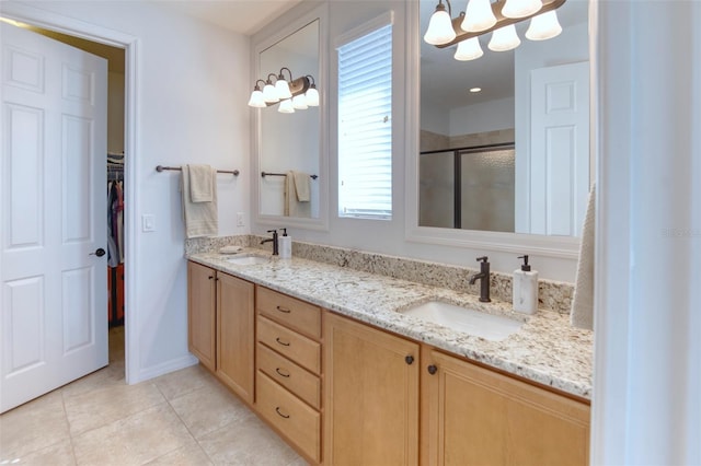 bathroom featuring tile patterned flooring, vanity, and a shower with door