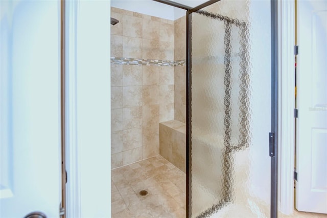 bathroom with a shower with door