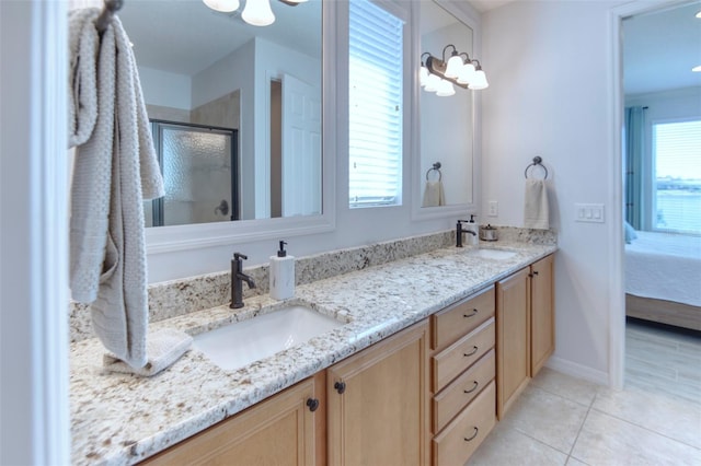 bathroom featuring tile patterned floors, vanity, and a shower with door