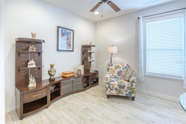 sitting room with ceiling fan and light hardwood / wood-style floors