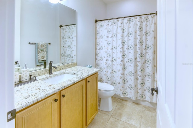 bathroom featuring tile patterned flooring, vanity, and toilet