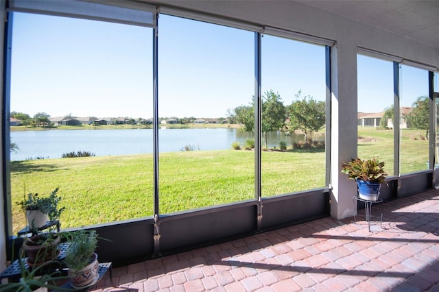 unfurnished sunroom with plenty of natural light and a water view