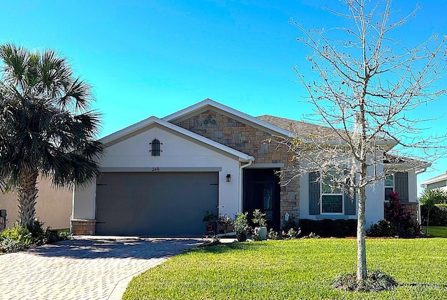 view of front of home featuring a garage and a front lawn