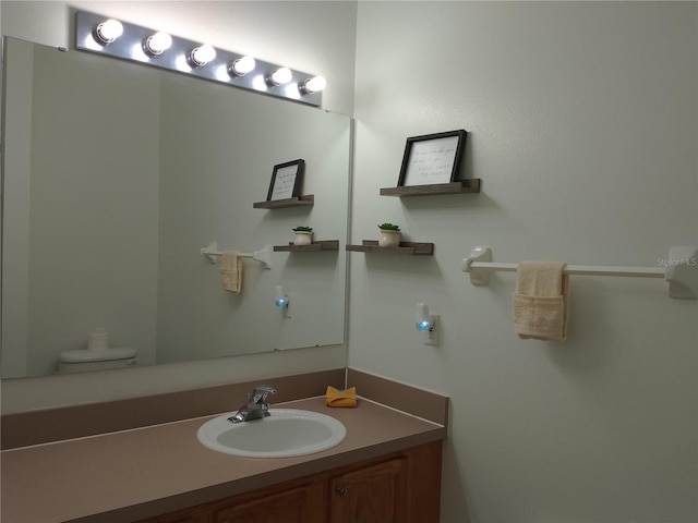 bathroom featuring vanity and toilet