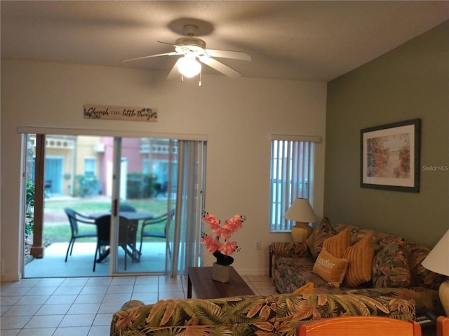 living room featuring ceiling fan, light tile patterned flooring, and a wealth of natural light