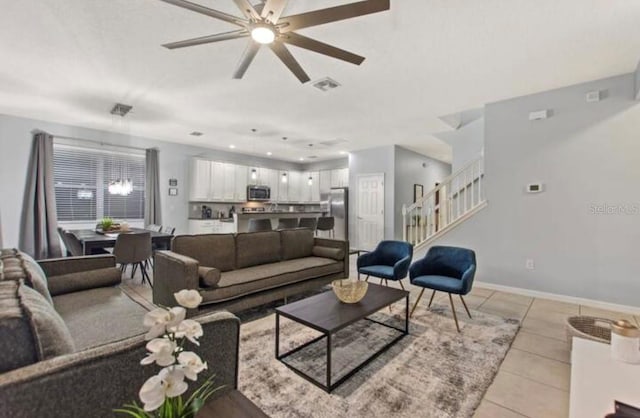 living room featuring ceiling fan and light tile patterned floors