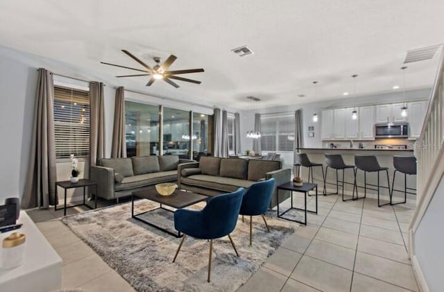 tiled living room featuring ceiling fan