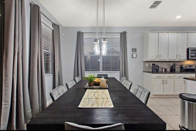 dining area featuring a chandelier and light tile patterned floors