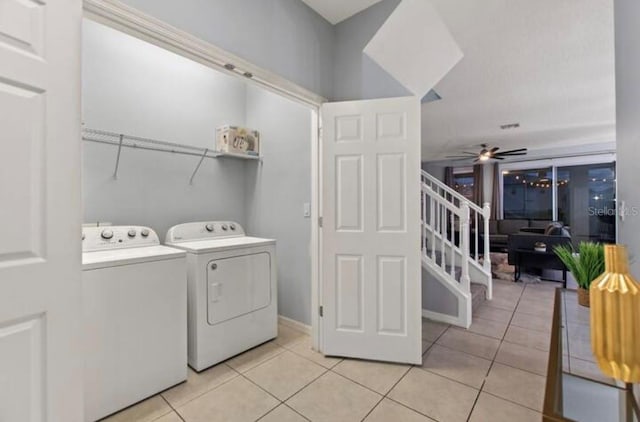 washroom with ceiling fan, washer and clothes dryer, and light tile patterned floors