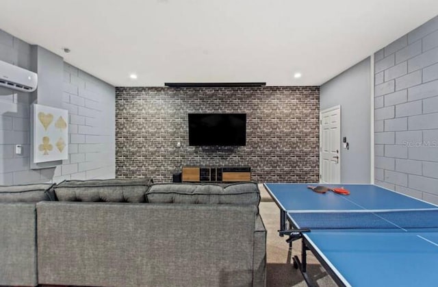 recreation room featuring an AC wall unit and carpet flooring