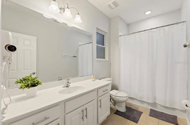 full bathroom with tile patterned flooring, vanity, toilet, and shower / tub combo with curtain