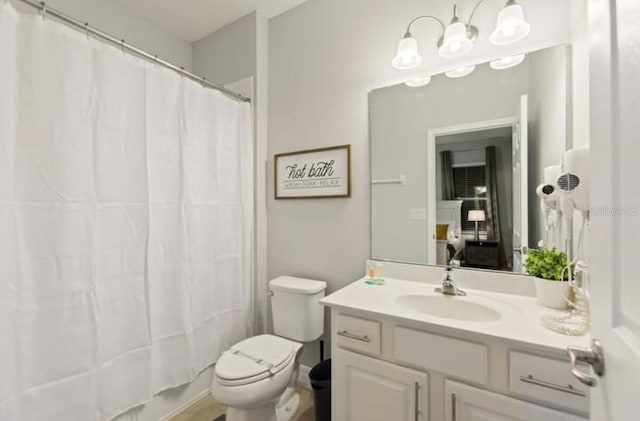 full bathroom featuring shower / bath combo, vanity, and toilet